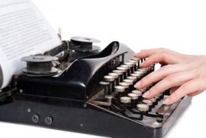 hands-typing-on-classic-typewriter
